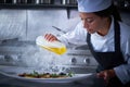 Chef woman working in kitchen with smoke Royalty Free Stock Photo