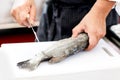 Chef at work, chef filleting fish at the kitchen, Chef in restaurant kitchen filleting fish Royalty Free Stock Photo