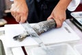 Chef at work, chef filleting fish at the kitchen, Chef in restaurant kitchen filleting fish Royalty Free Stock Photo