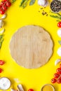 Chef work space with products and cutting board on yellow background top view mock up Royalty Free Stock Photo