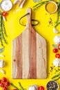 Chef work space with products and cutting board on yellow background top view mock up Royalty Free Stock Photo