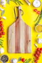 Chef work space with products and cutting board on yellow background top view mock up Royalty Free Stock Photo