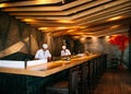 Chef working at Japanese Sushi bar with vaibrant interior, Wood Royalty Free Stock Photo