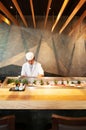 Chef working at Japanese Sushi bar with vaibrant interior, Wood Royalty Free Stock Photo