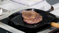 A chef working in the kitchen. Frying a piece of steak in the pan