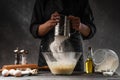 Chef works with flour. Bakery preparing bread and pastries. Freezing in motion