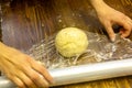 The chef wraps the dough in plastic wrap, which should lie down for 30 minutes before cooking