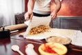 Chef wraps the filling into dough, apple strudel