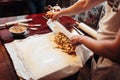 Chef wraps the filling into dough, apple strudel