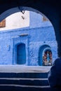 CHEFCHAOUEN, MOROCCO - APRIL 05, 2023 - Vibrant blue colored alley in downtown Chefchaouen