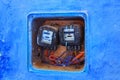 CHEFCHAOUEN, MOROCCO - MAY 29, 2017: Old electric meters on the blue wall in the historical part of Chefchaouen, Morocco