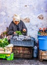 Chefchaouen, Morocco - October 20, 2013. Daily life in famous blue city - old woman selling herbs