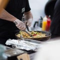 Cheff cooking on outdoor street food festival. Royalty Free Stock Photo