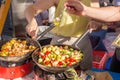 Cheff cooking traditional Mediterranean octopus on street stall. Royalty Free Stock Photo