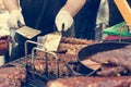 Cheff preparing delicious barbeque spare ribs on a grill.