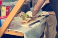 Cheff preparing delicious burgers - view from the side of food stand.