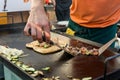 Cheff preparing traditional Mediterranean squid dish on a hot grill.