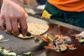 Cheff preparing traditional Mediterranean squid dish on a hot grill.