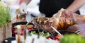 Cheff serving traditional meat dish on street stall on street food festival, Ljubljana, Slovenia. Royalty Free Stock Photo