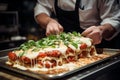 Chefs adding final touches to a perfectly baked parmigiana