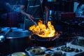 The chefs are cooking with fire over the pan, at street food dining options in all of Bangkok, Yaowarat road or Chinatown Thailand Royalty Free Stock Photo