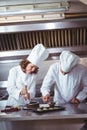 Chefs decorating a cake