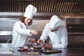 Chefs decorating a cake