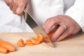 Chefs hands chopping carrot Royalty Free Stock Photo