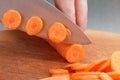 Chefs hands chopping carrot on wooden board Royalty Free Stock Photo