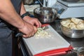 Chef`s hands cut a green peeled pear. Cooking caramelize Pears and cook chutney. close up