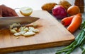 Chefs hands with knife chopping vegetables