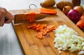 Chefs hands with knife chopping vegetables