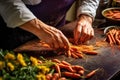 chefs hands peeling and chopping fresh carrots