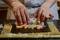 chefs hands rolling sushi on a bamboo mat Royalty Free Stock Photo