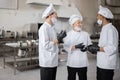 Chefs have some conversation in the professional kitchen at job Royalty Free Stock Photo