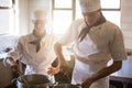 Chefs preparing food at stove Royalty Free Stock Photo