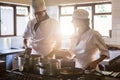 Chefs preparing food at stove Royalty Free Stock Photo