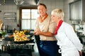 Chefs in a restaurant or hotel kitchen cooking Royalty Free Stock Photo