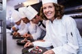 Chefs team finishing dessert plates Royalty Free Stock Photo