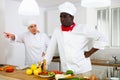 Chefs in white uniform having conflict on kitchen