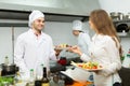 Chefs and young waiter Royalty Free Stock Photo