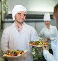 Chefs and young waiter Royalty Free Stock Photo