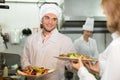 Chefs and young waiter Royalty Free Stock Photo