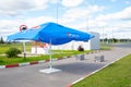 Chekshino, Vologda, Russia, 08/19/2020. Large blue umbrella with the Pepsi logo at a gas station on a summer day