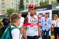 Chelm, Lubelskie, Poland - July 31, 2022: 79 Tour de Pologne, A rider from the UAE Team Emirates group talks to a young fan