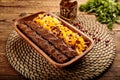 Chelo Kebab Kobideh served in a wooden cutting board isolated on wooden background side view