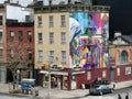 Chelsea Square Market on 10th Ave. Colorful corner building with images of Ghandi and Mother Theresa.