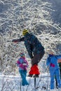 Chelyabinsk Oblast, Russia - Febrary 8, 2015: man walking on slackline in sunny winter day, view from the back. Royalty Free Stock Photo