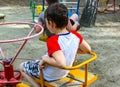 Chelyabinsk, Russia-August 08, 2020:Children spin on a spinning carousel on the Playground in summer