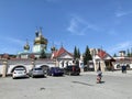 Chelyabinsk, Russia, June, 12, 2021. An elderly hunched woman in front of St. Simeon Cathedral in summer in clear weather